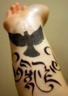 tribal dove tattoo on wrist